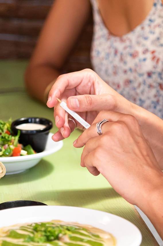 Slidderz Cannabis Branding - Hands Using Joint at Dinner
